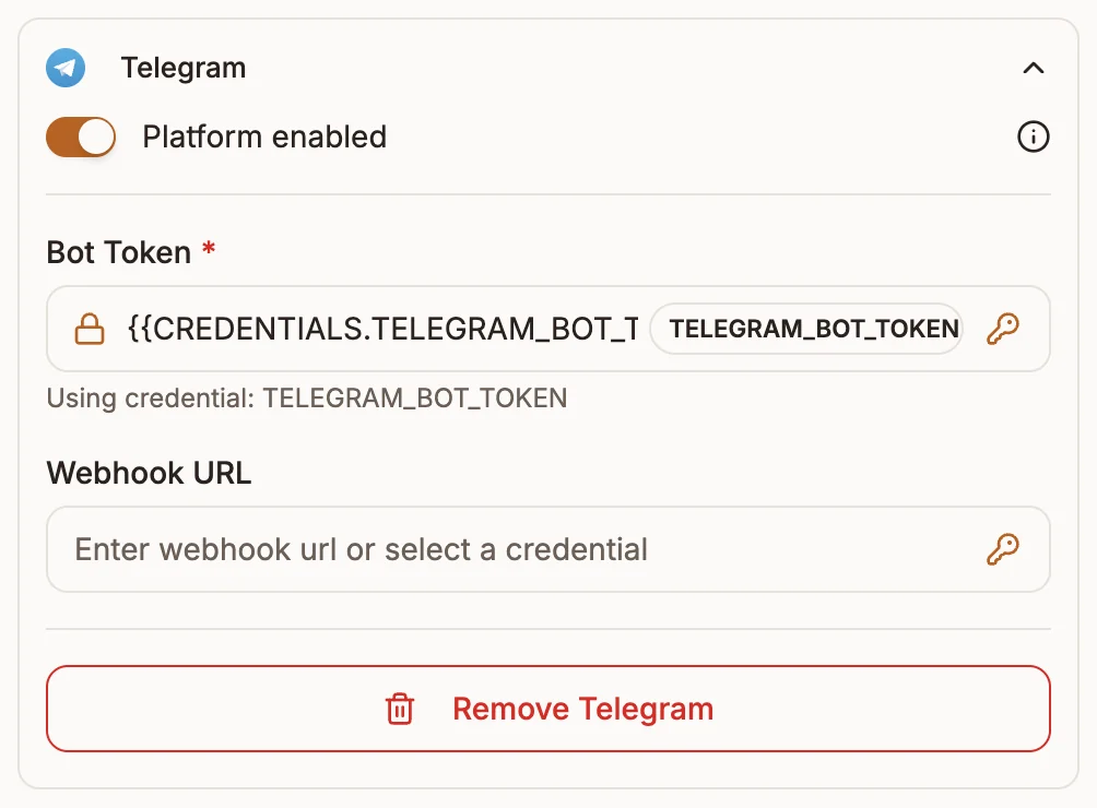 The Telegram section of the trigger node's Platforms tab with the Bot Token field set to a placeholder credential